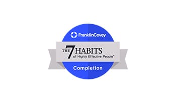 A blue and white badge with the words " franklincovey completion " on it.